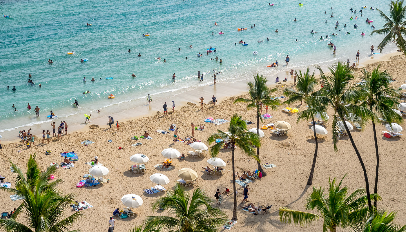 Overhead view of sunbathers and umbrellas on Waikiki beach in Honolulu