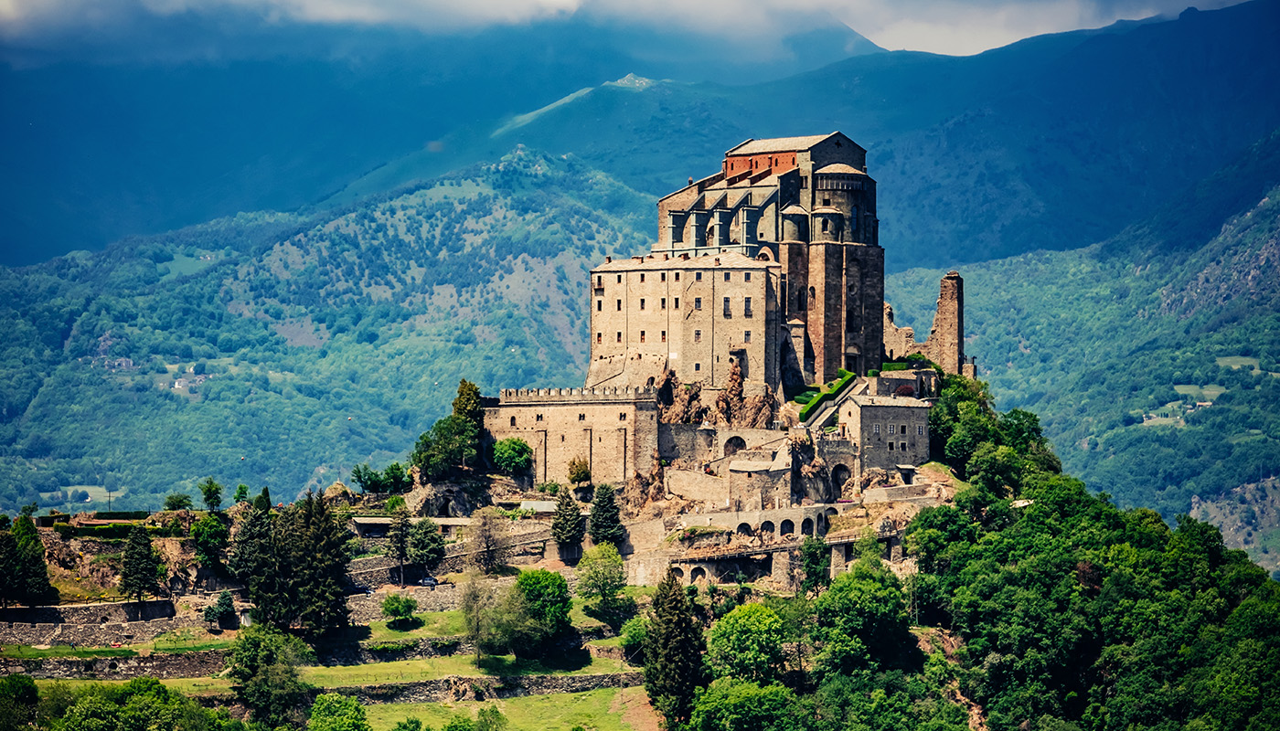 A castle perched on a hilltop in the mountains.