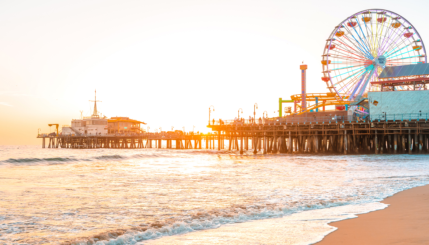 The Santa Monica pier with its towering ferris wheel at sunset. 