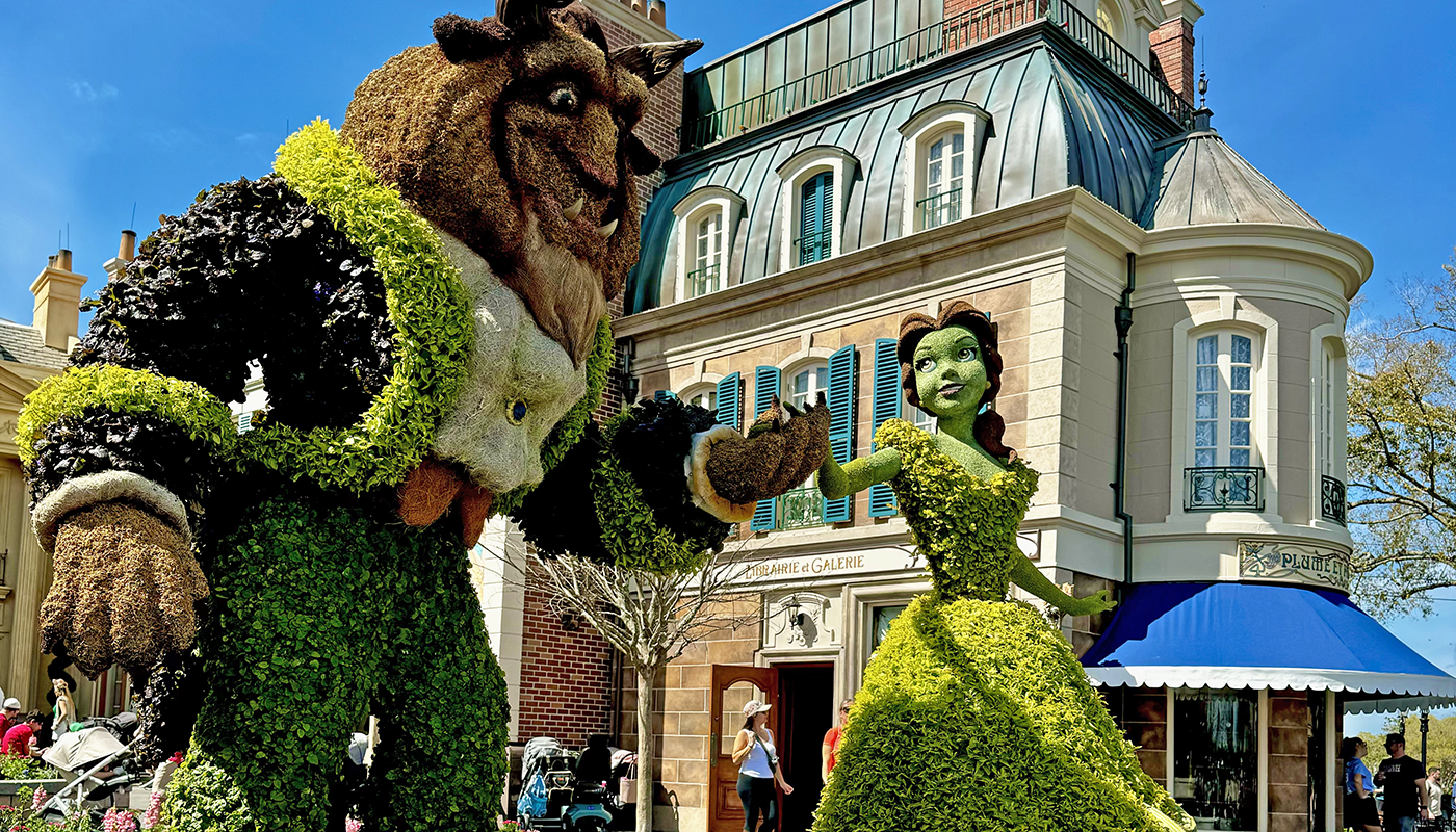 Plant sculptures of Belle and the Beast are on display in Magic Kingdom