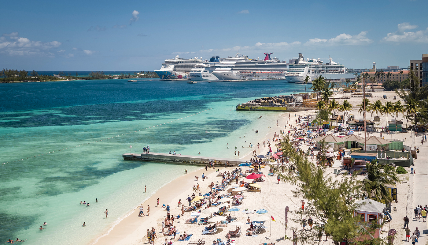 Cruise ships and tourists on Junkanoo Beach in Nassau, Bahamas