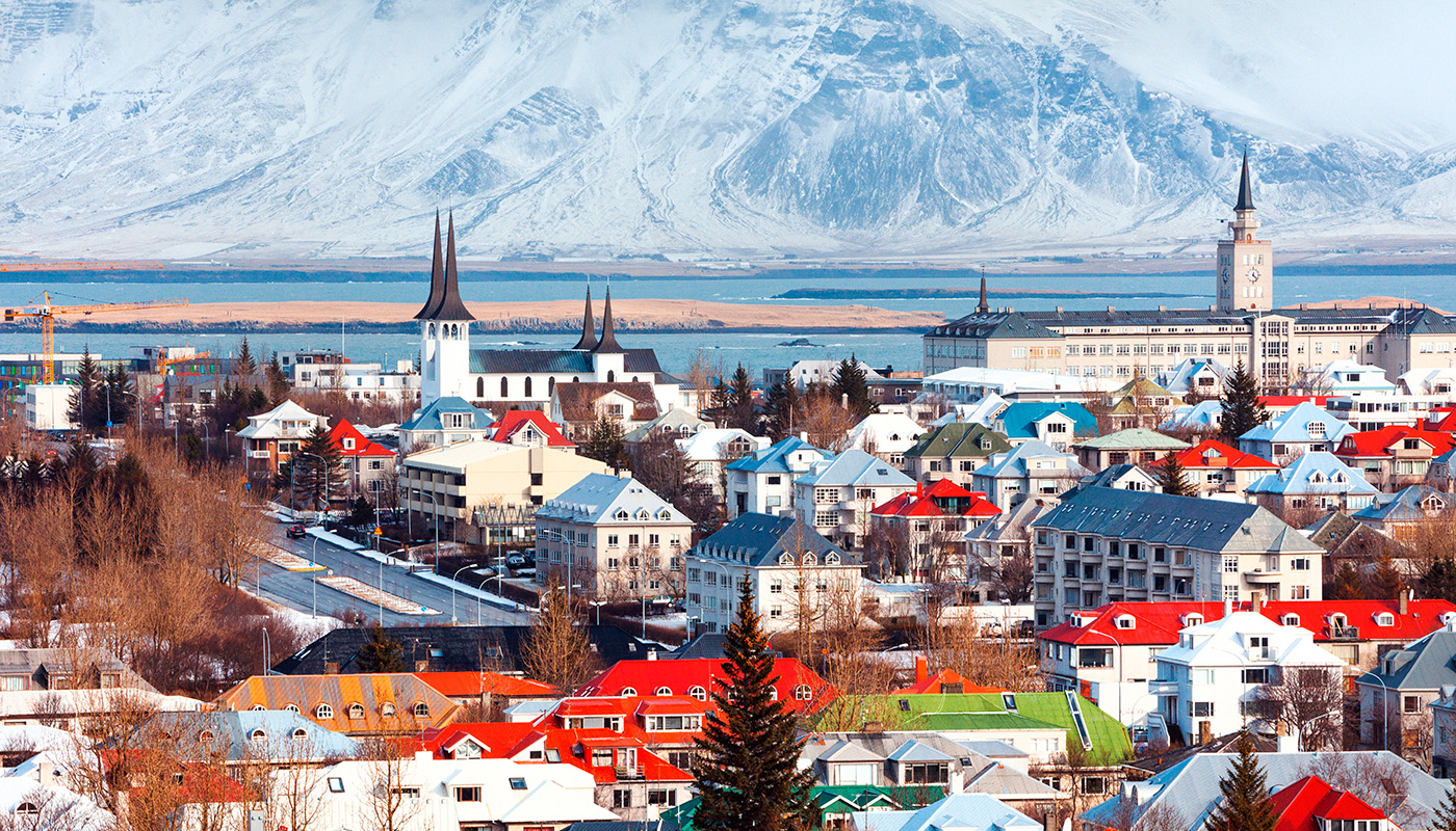 Aerial view of downtown Reykjavik with sea and mountain in background