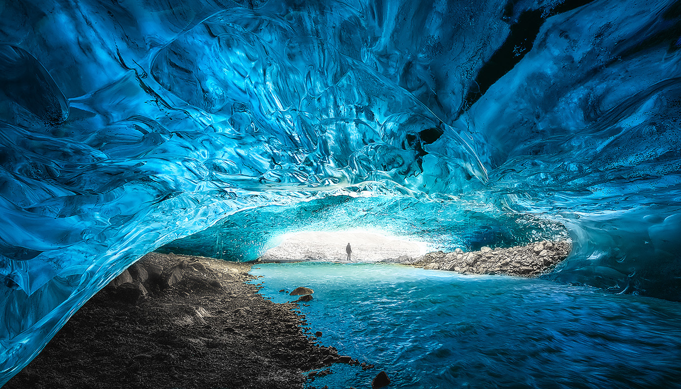 Man exploring Blue Ice cave at Vatnajökull National Park