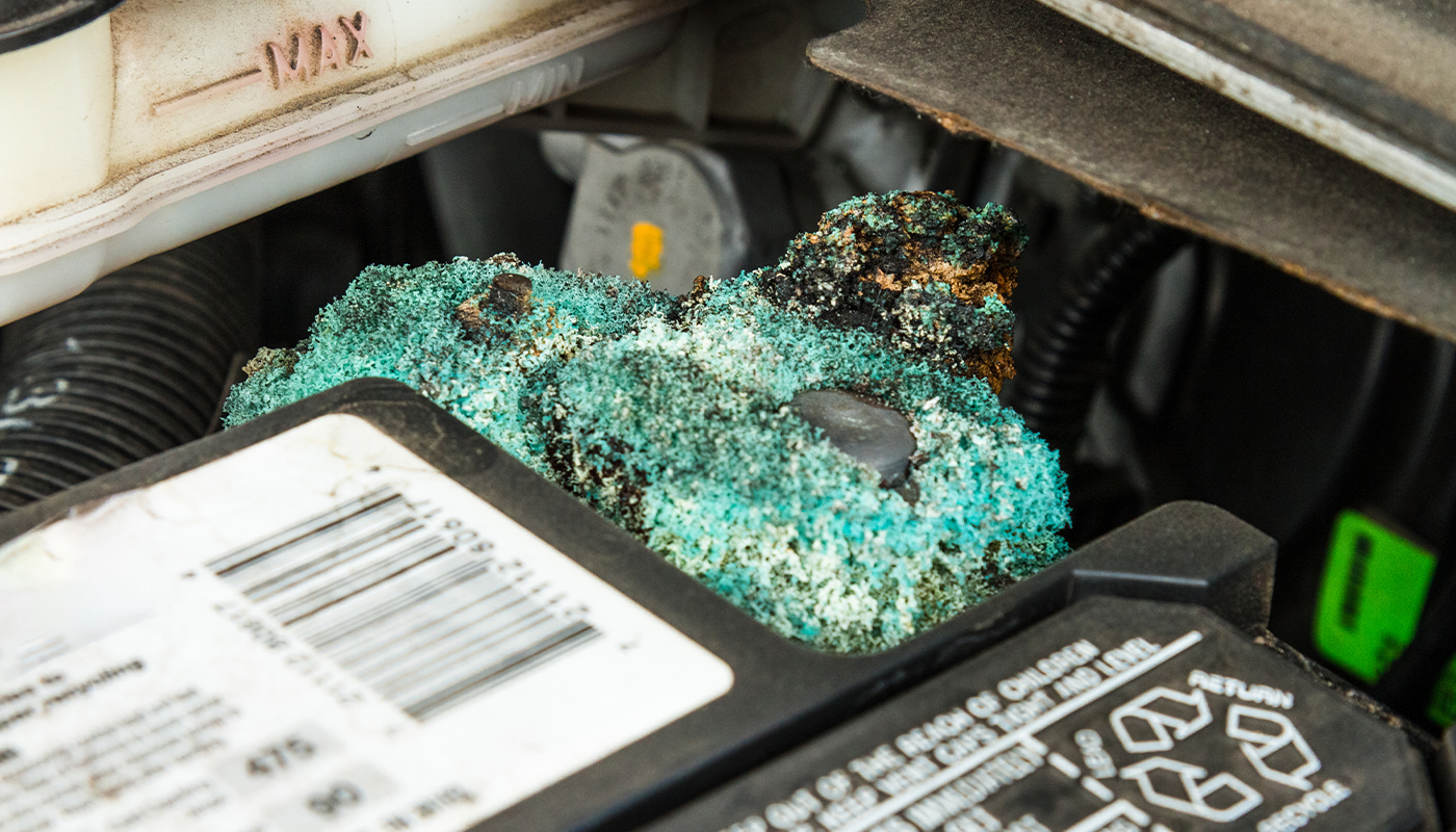 A close-up of corrosion on a car battery.