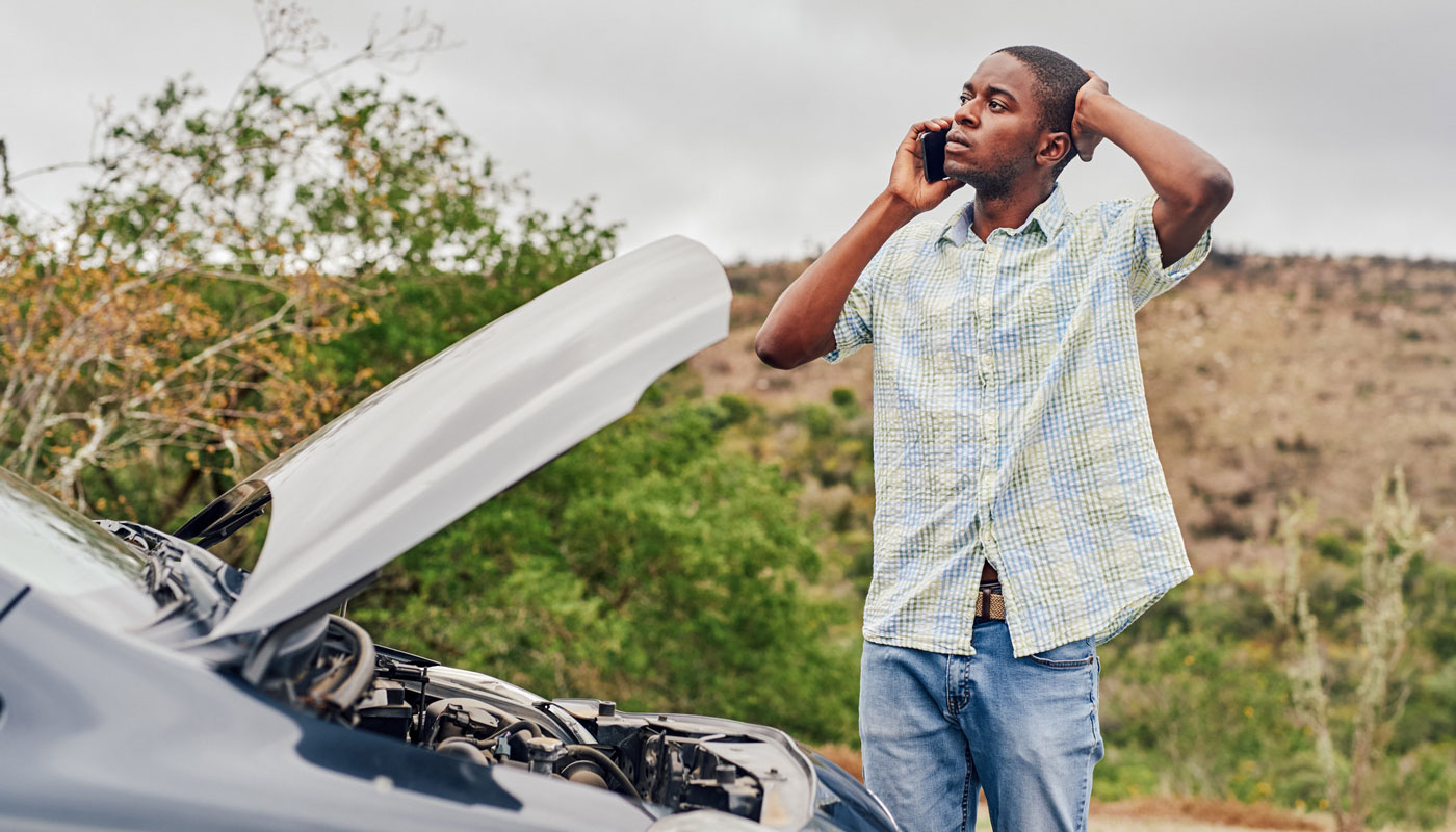 man standing by car with hood up