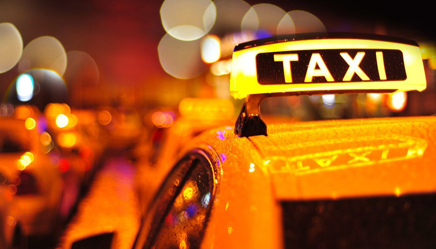 Closeup of yellow taxi with bokeh lighting