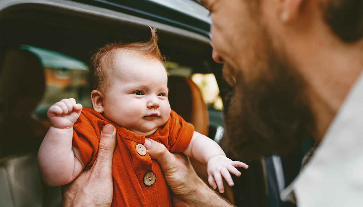 Father take baby out of car happy family lifestyle dad and child together parenthood childhood concept