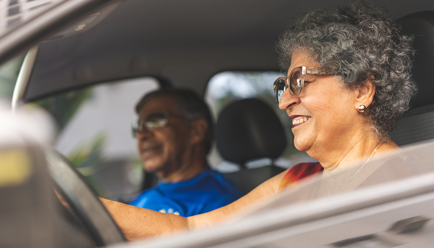 Senior woman driving with senior man in passenger seat