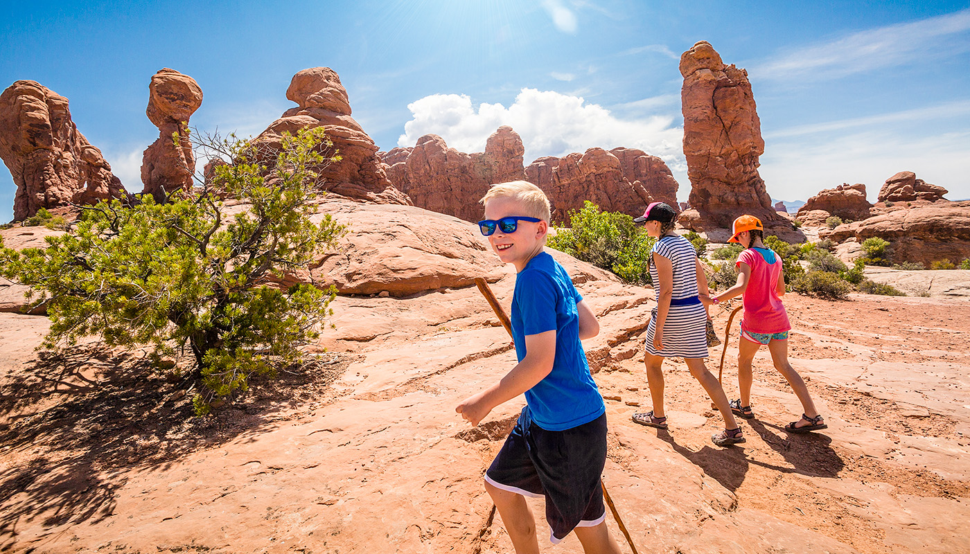 Family hiking during the day at Arches National Park