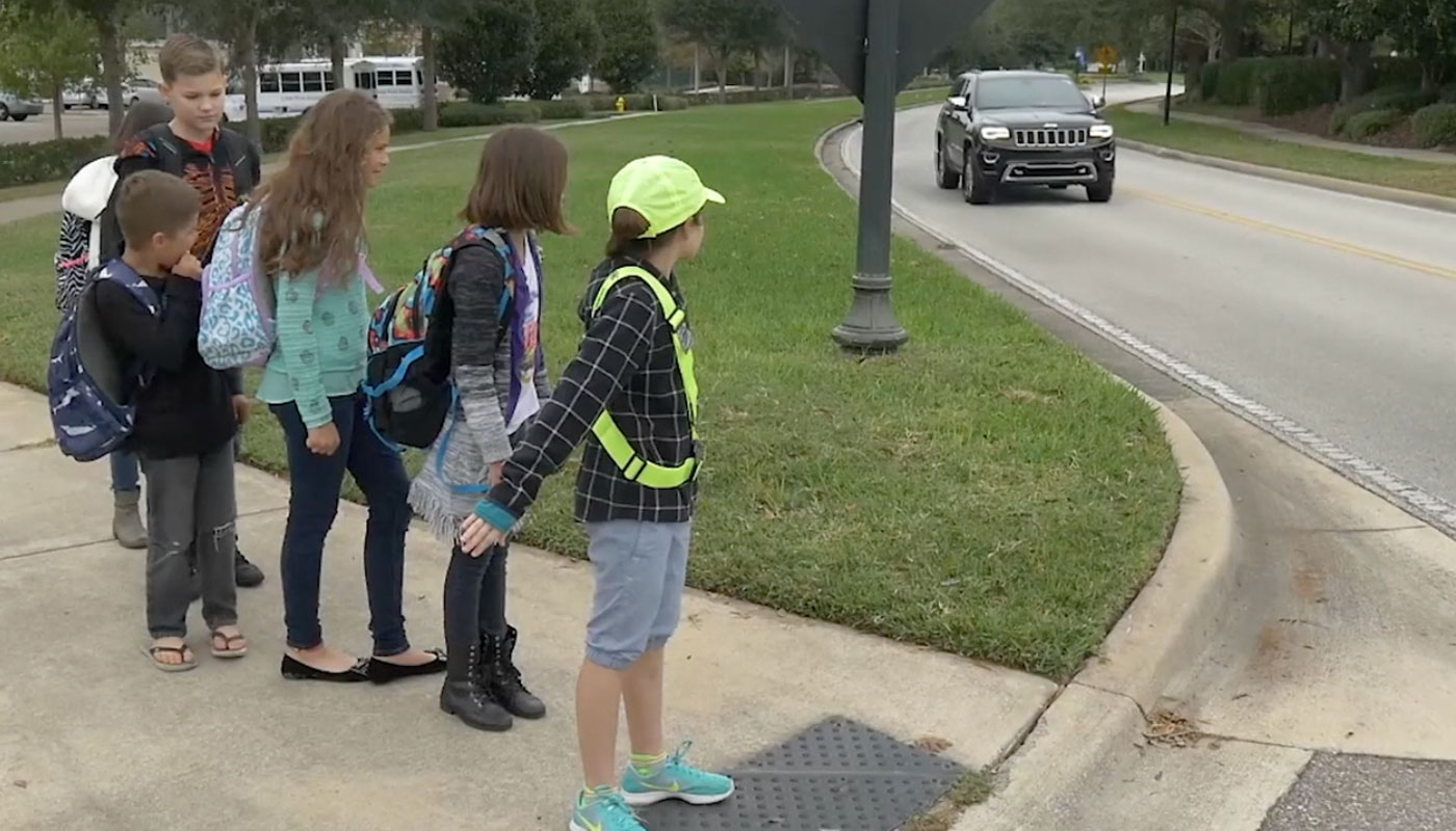 Safety patroller protecting other students from the street.