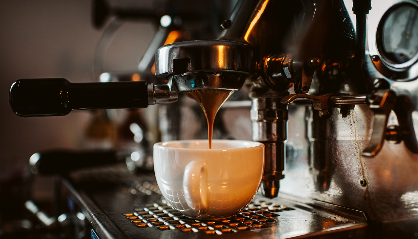 Espresso machine pouring coffee into a cup