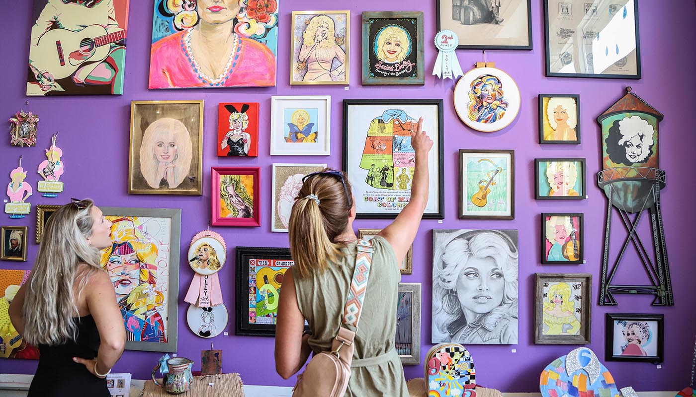 Shoppers look at wall of Dolly Parton art in Rala