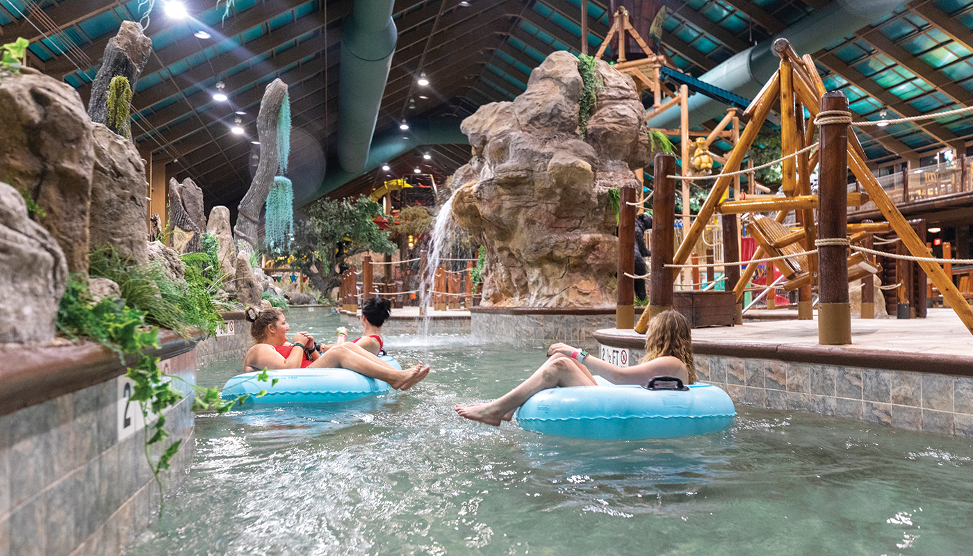 Hotel guests lazing in inner tubes in an indoor waterpark