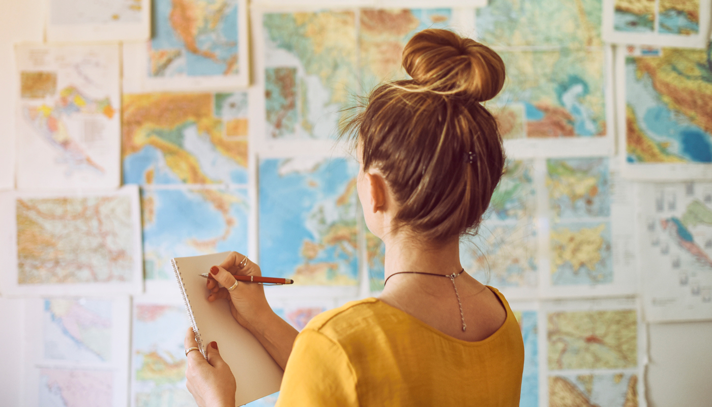 Woman making a Wonderlust wish list for travel