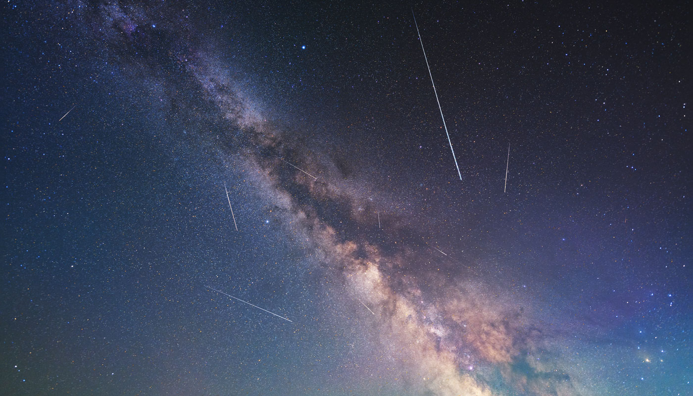 milkyway in the night sky with perseid meteor shower
