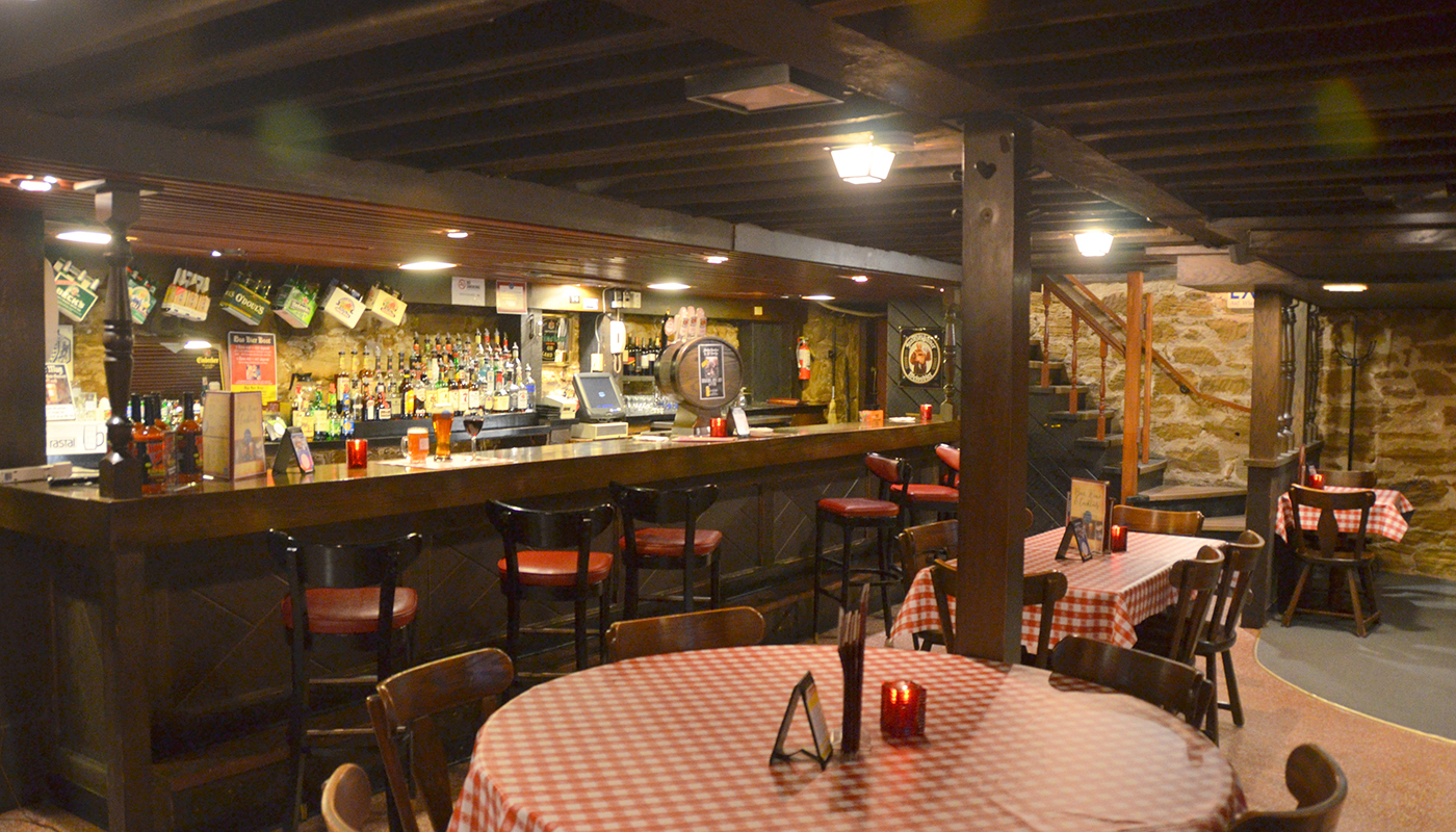 Dining area of the Ox Yoke Inn with bar and tables. 