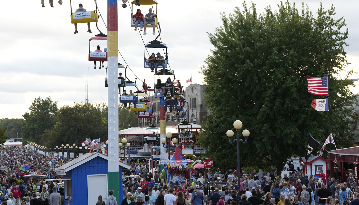 Revelers enjoy the midway at the Iowa State Fair.