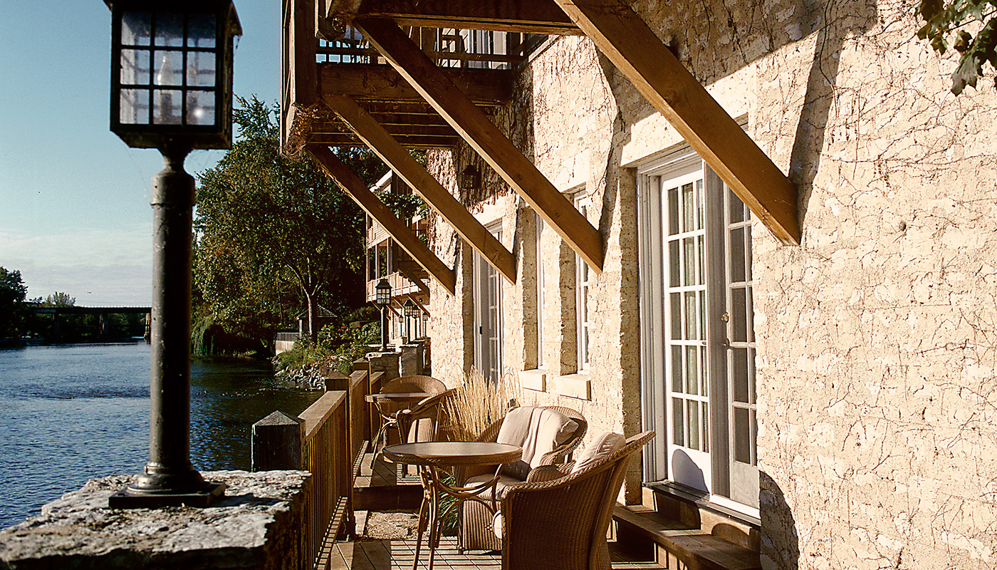 Exterior view of outdoor sitting area at the Herrington Inn and Spa. The Fox River is on the left.