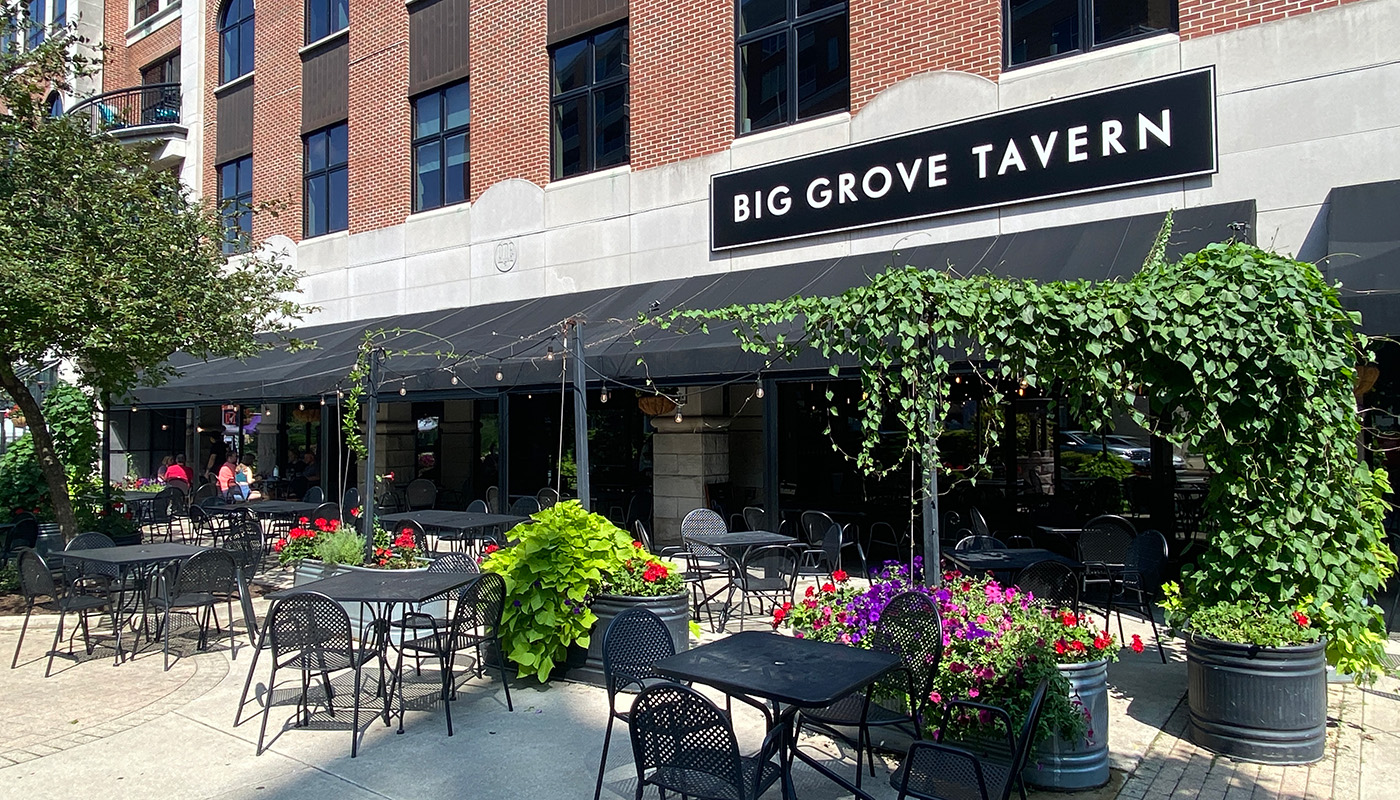 Outdoor dining at the Big Grove Tavern, surrounded by greenery