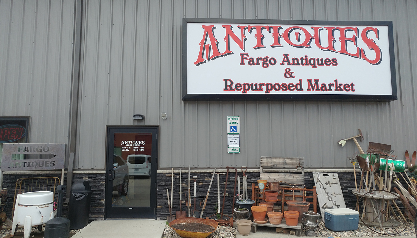 A sign on a building reads, “Fargo Antiques & Repurposed Market.”