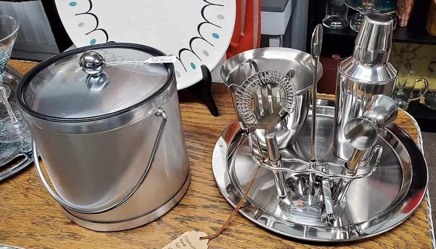 A vintage ice bucket and set of cocktail tools.