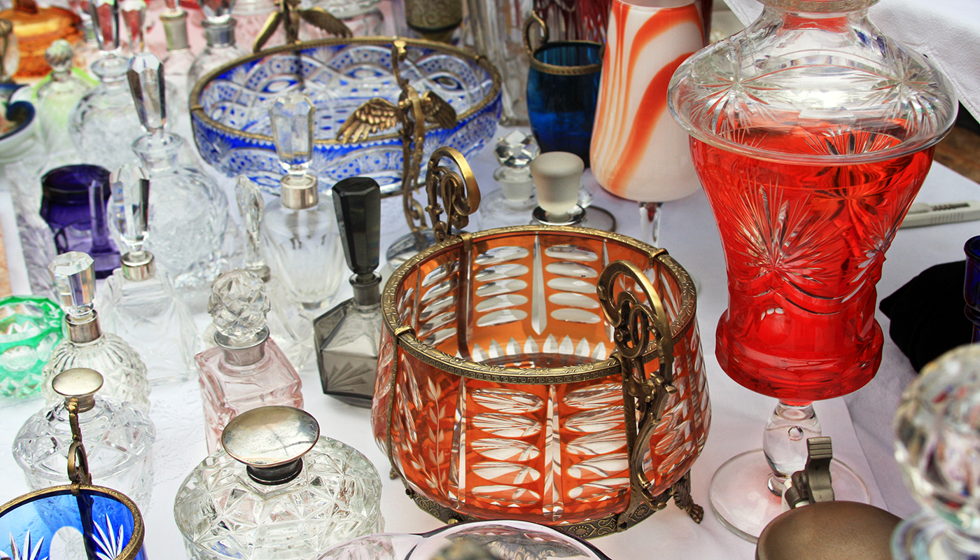 Colorful antique glassware including vases, perfume bottles and pots.