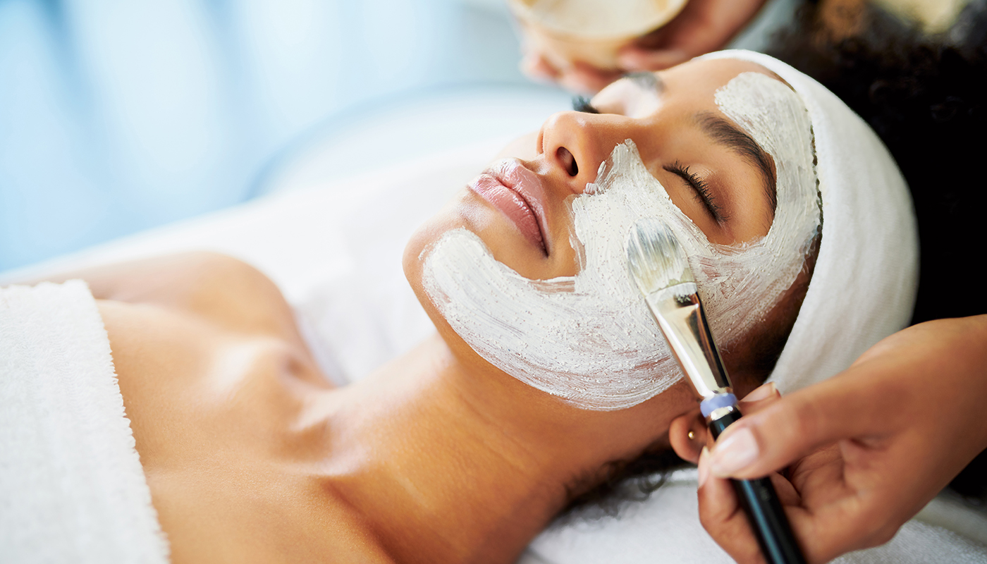 Woman getting a facial at a beauty spa