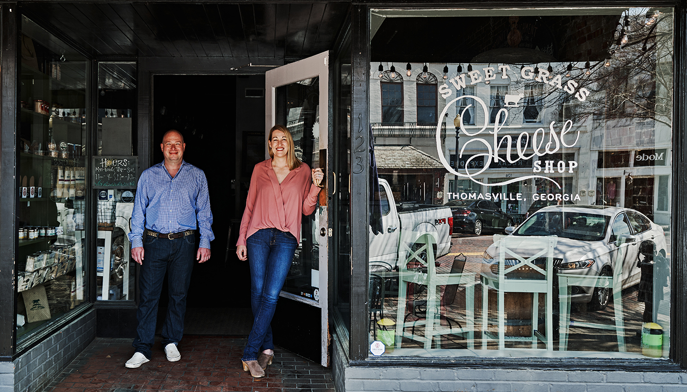 Owners of the Sweet Grass Dairy & Cheese Shop standing in front of their store