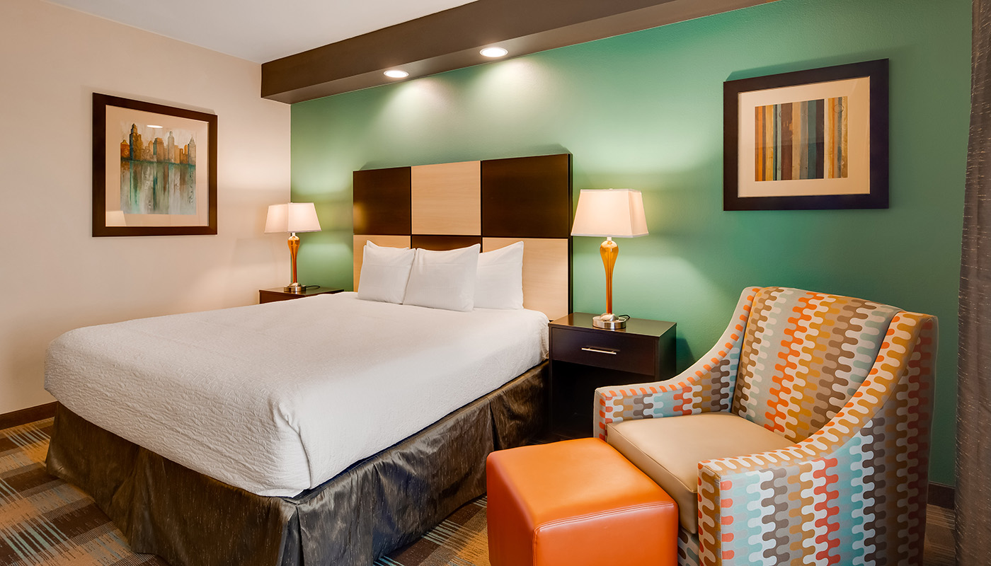 Brightly lit guest room with colorful modern decor and amenities