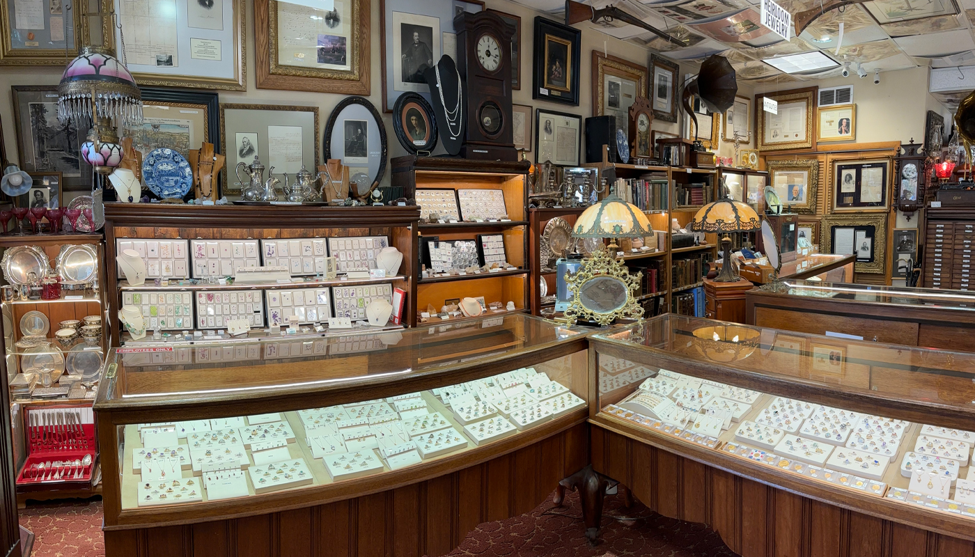 Large glass cases display jewelry in an antique store. 