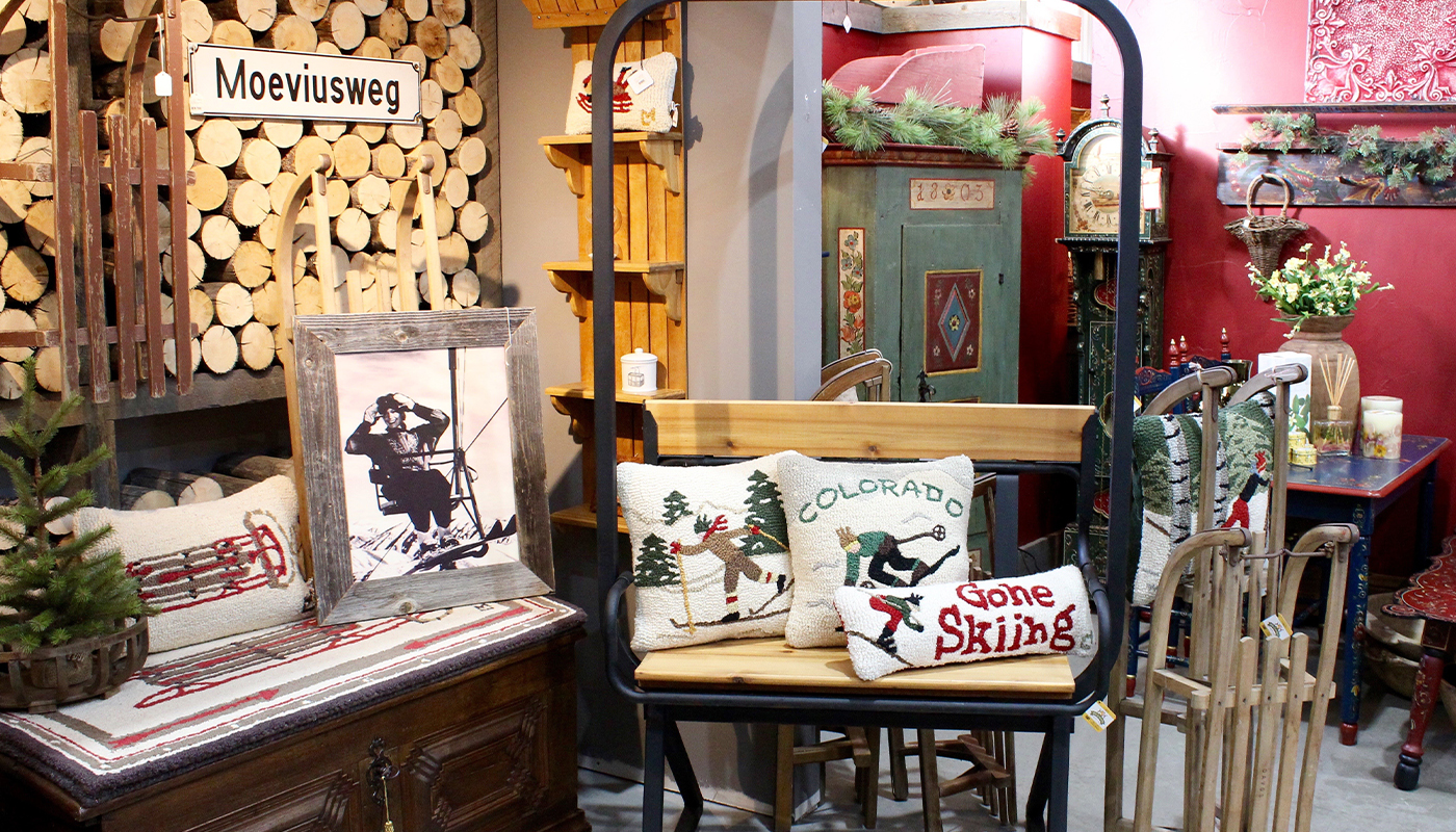 Decorative pillows depicting downhill and cross-country skiers on display in a shop.