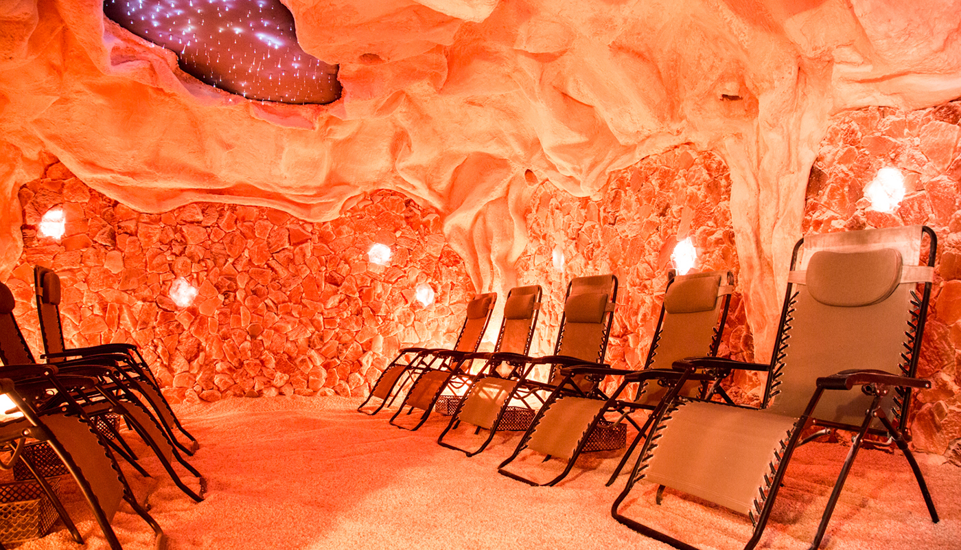 Reclining chairs in an illuminated pink Himalayan salt cave