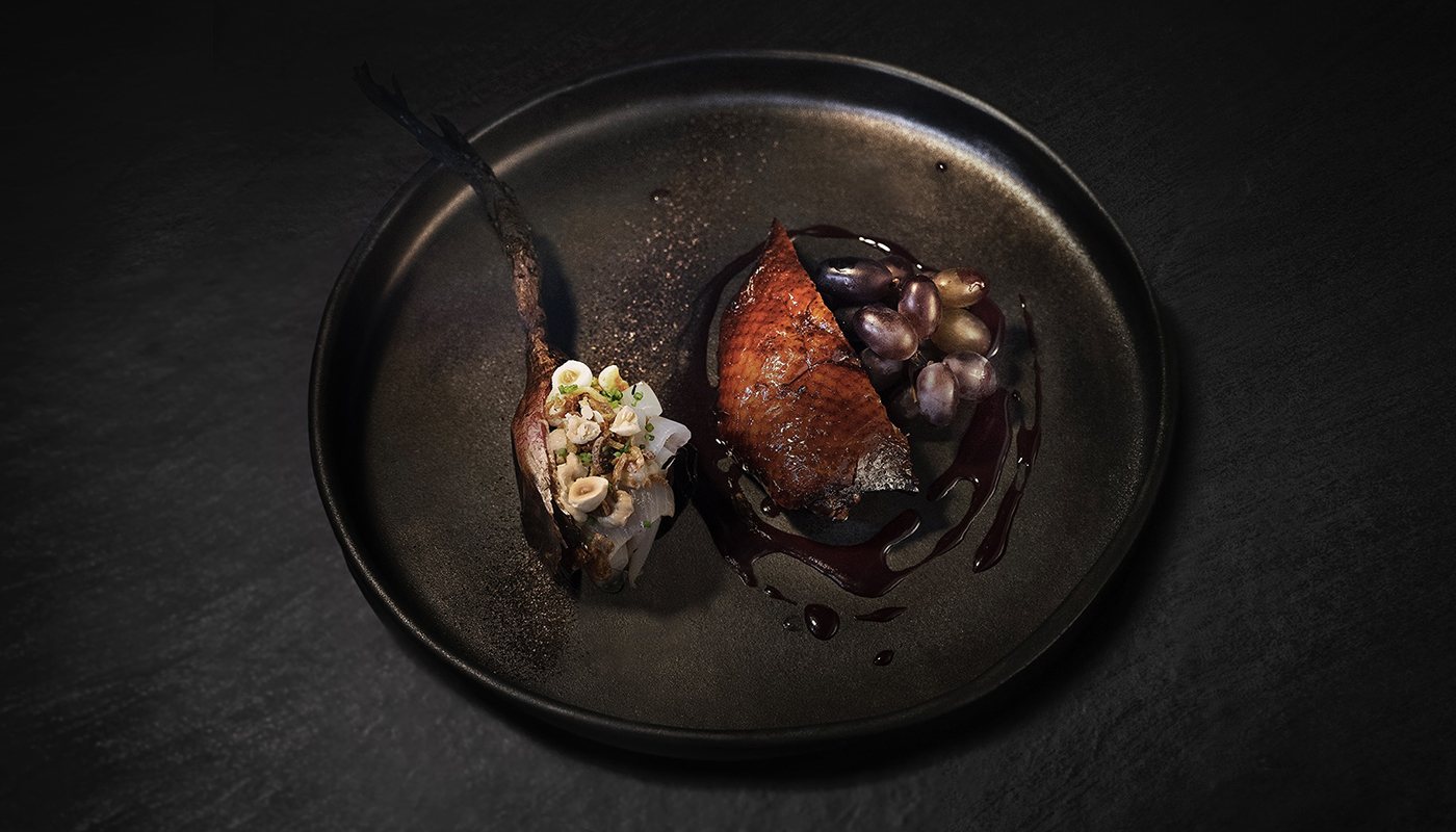 Stylish plate of food by BOSQ on a black background