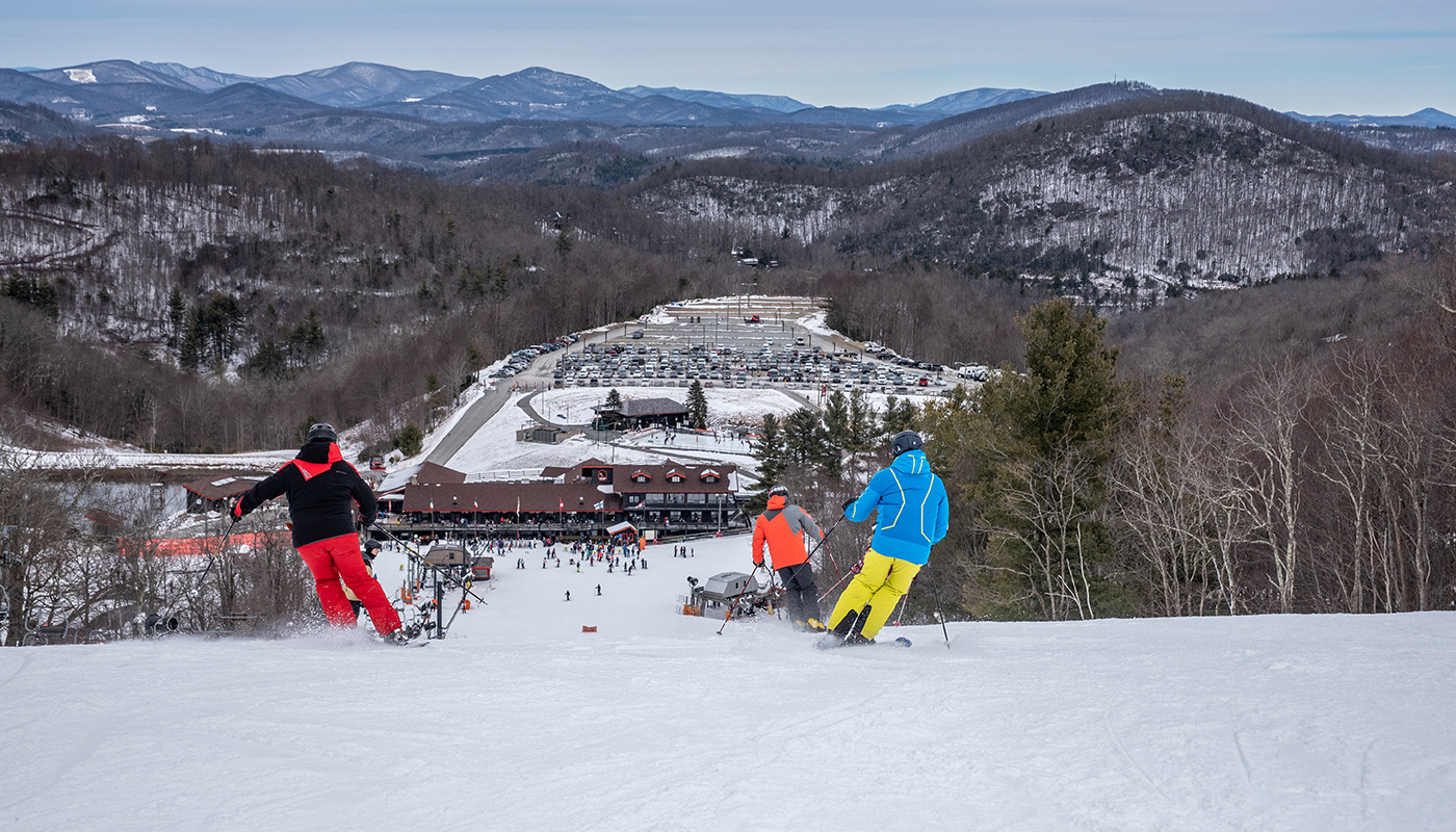 Various people skiing down a path on the French Swiss Ski College slopes at Appalachian Ski Mountain
