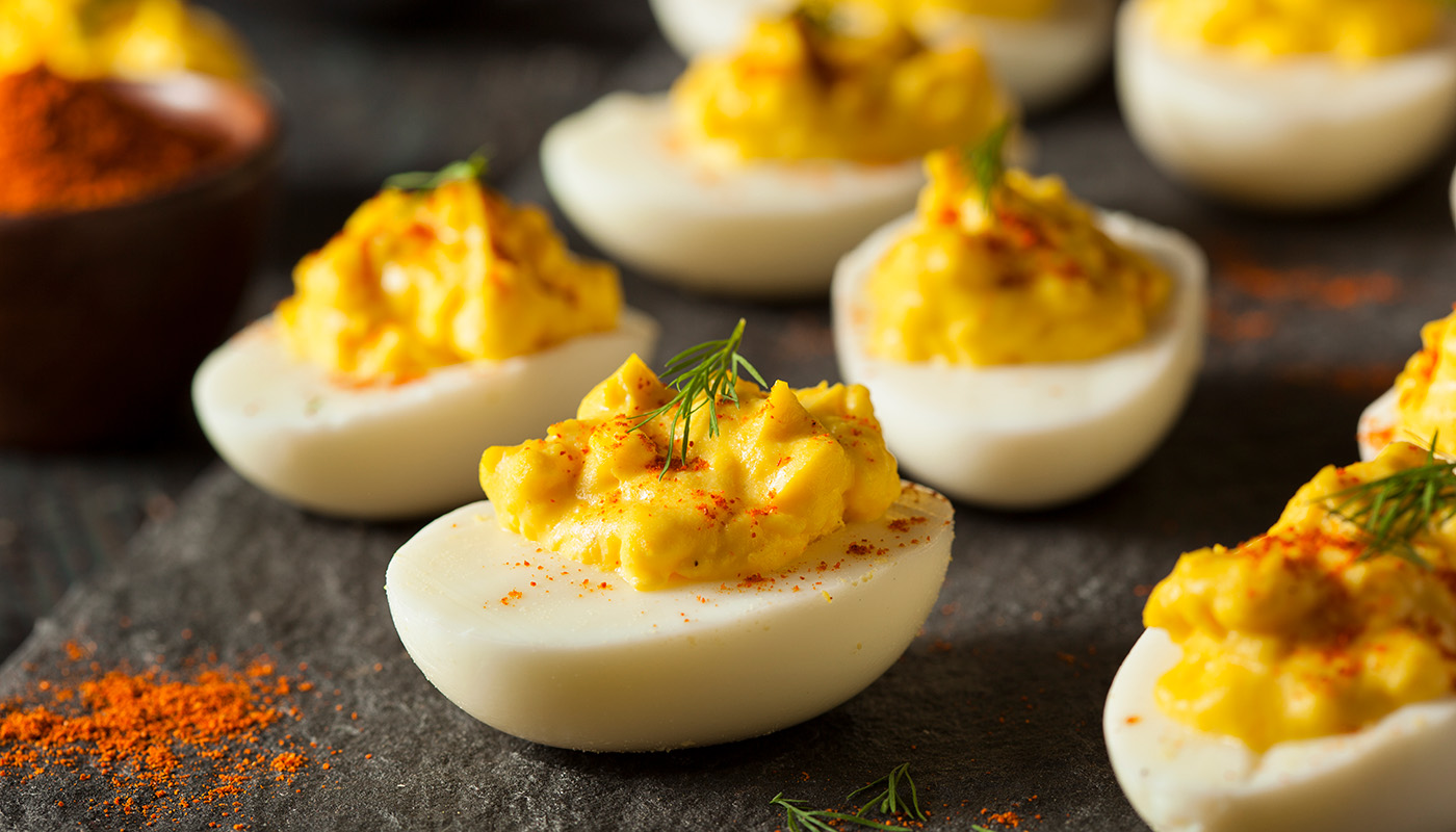 Close up of deviled eggs on dark surface