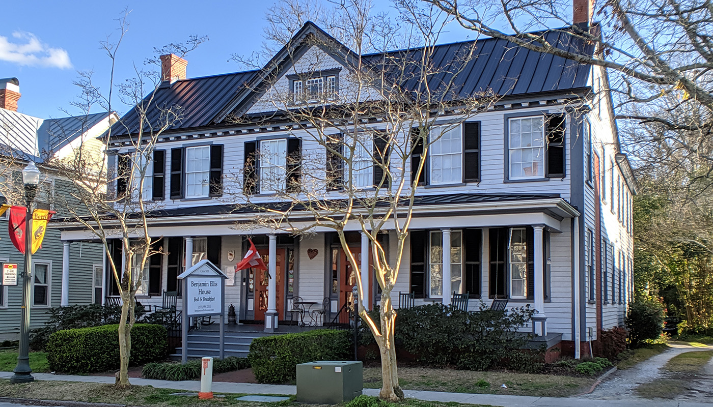 Exterior view of the Benjamin Ellis House Bed and Breakfast. The house is white and has large porch.