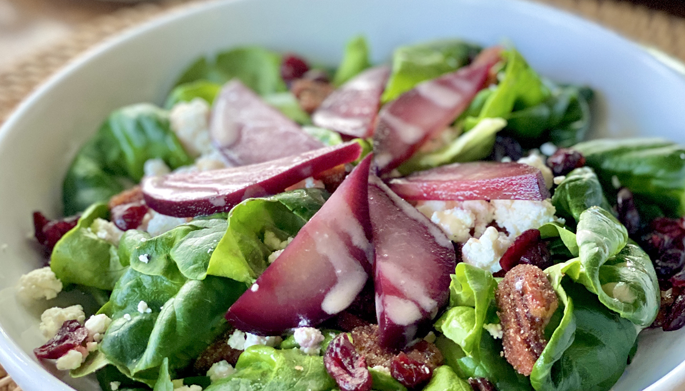 A salad with craisins, pears poached in red wine and chèvre. 