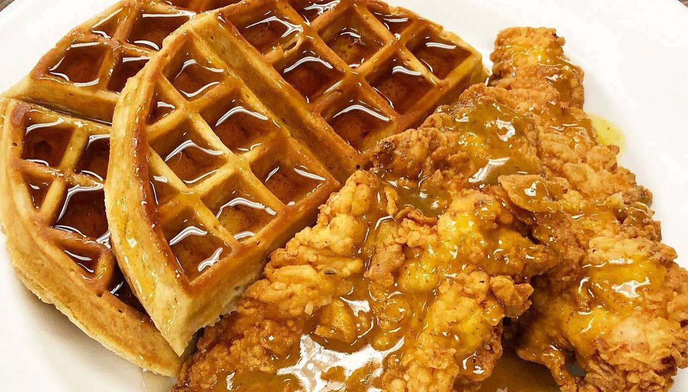 Fried chicken and waffles with syrup on a plate