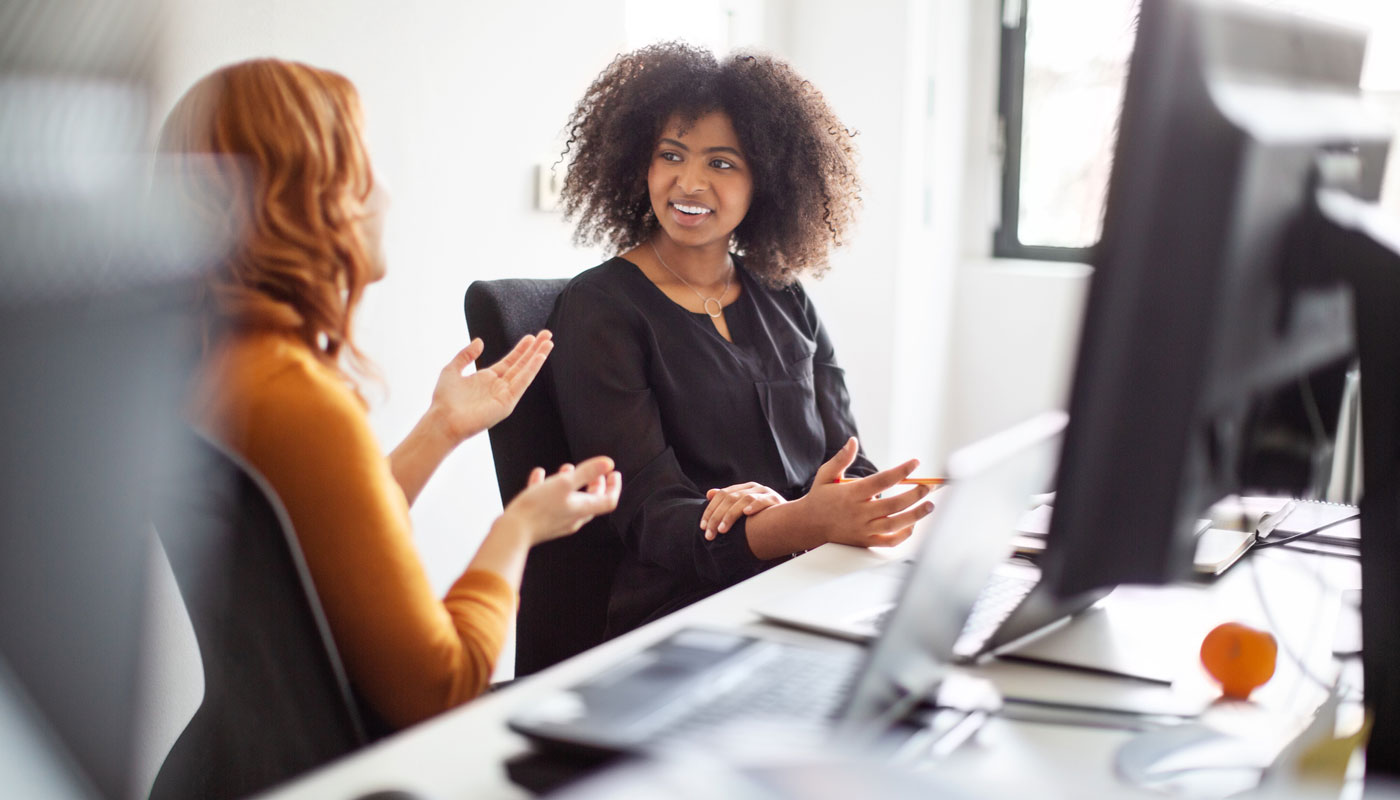 Woman working with another woman in career services