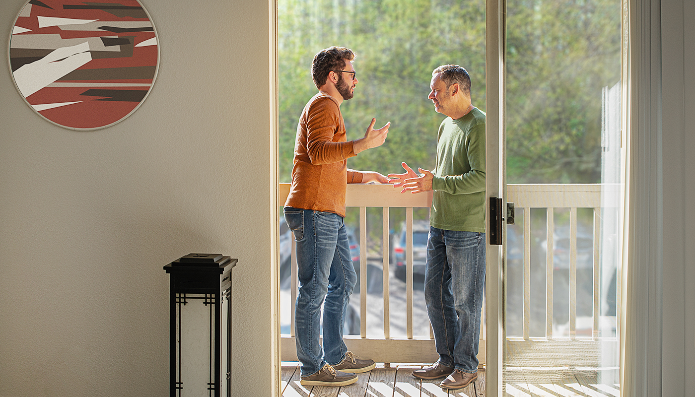 Brian and Mason Cook having a conversation out on balcony