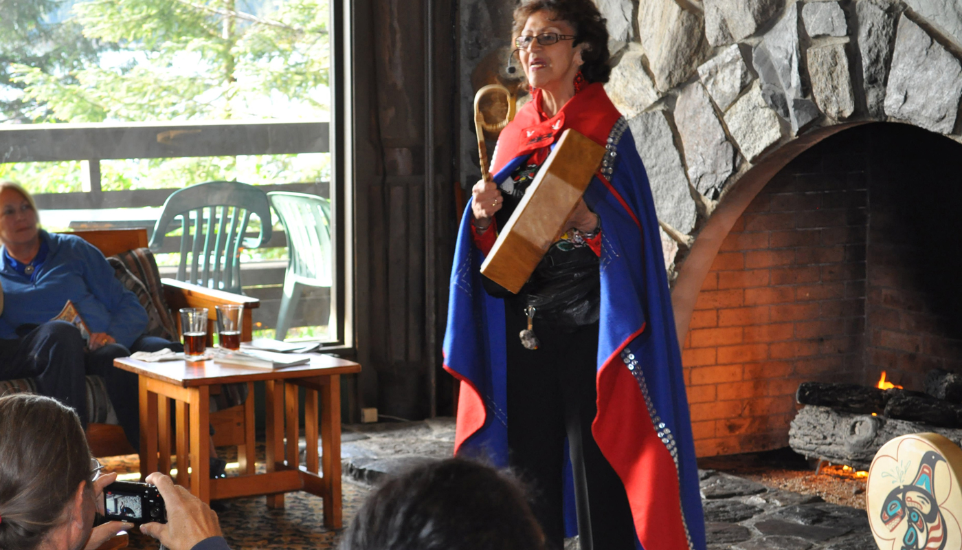 Native Alaska woman giving information to cruise passengers