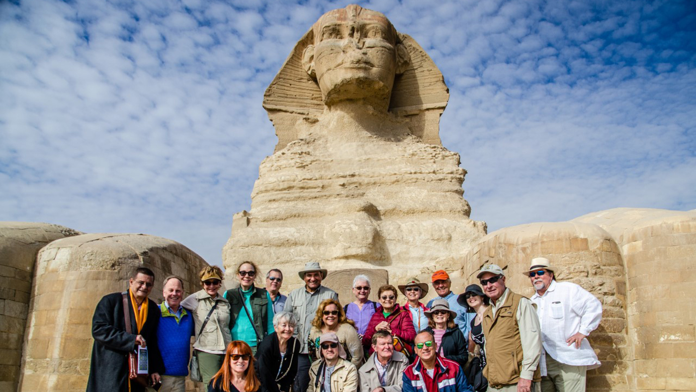 "Stand between the paws of the Sphinx "