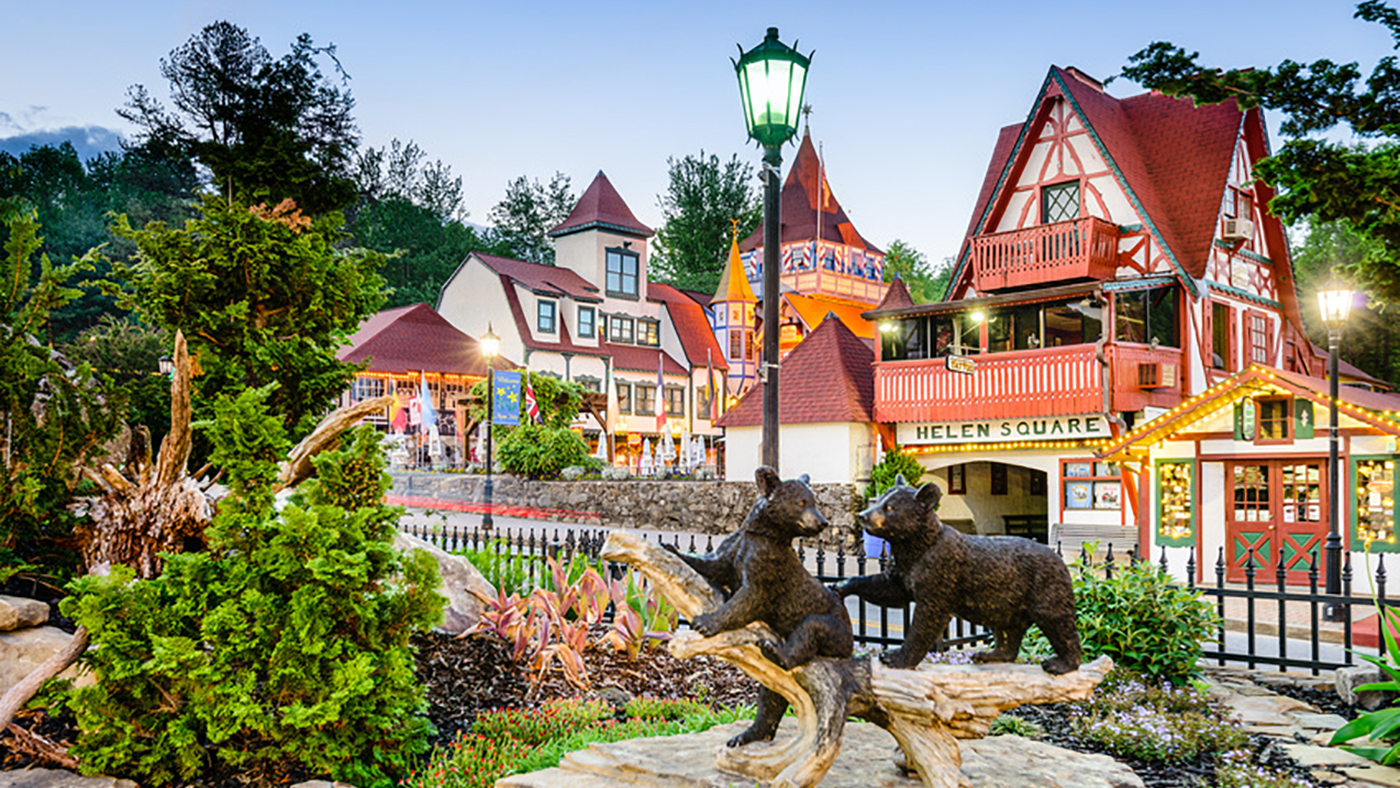 Photo of Bavarian style buildings in Alpine Square with bear cubs statue in the foreground.