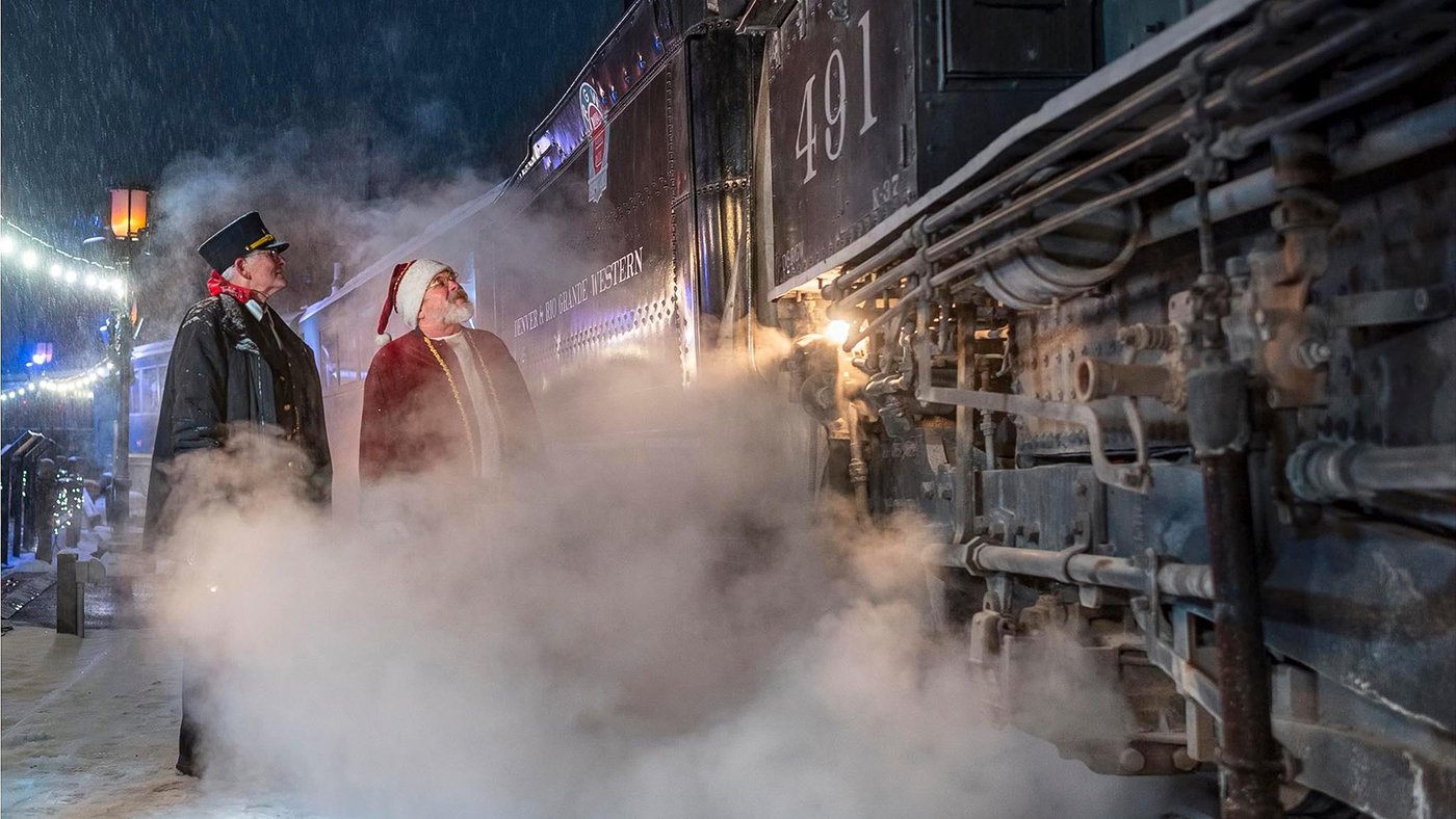 The conductor, Santa Claus, and engineer meet in a symphony of steam before THE POLAR EXPRESS™ departs from the Colorado Railroad Museum.