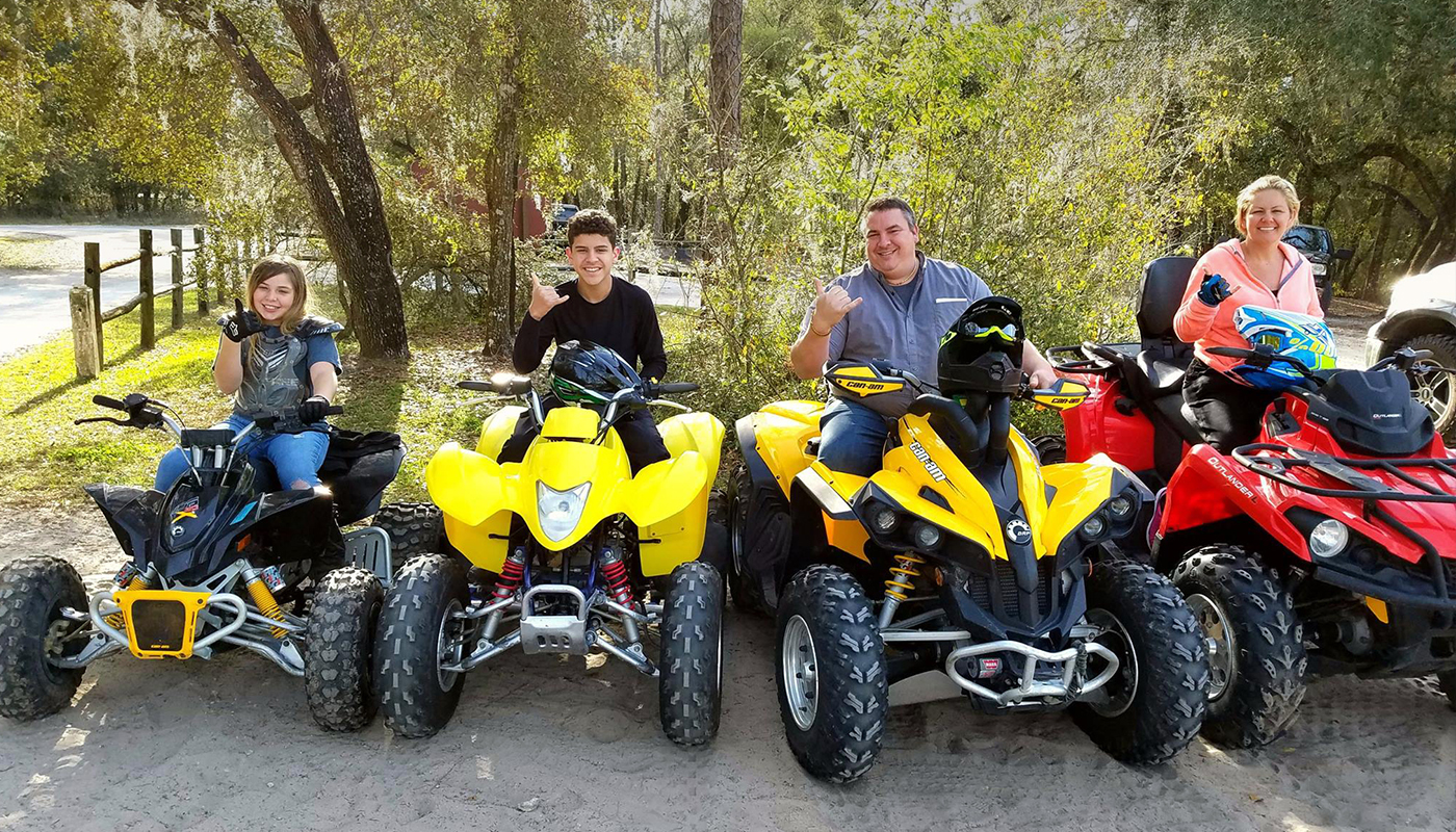 Four people on ATVs.