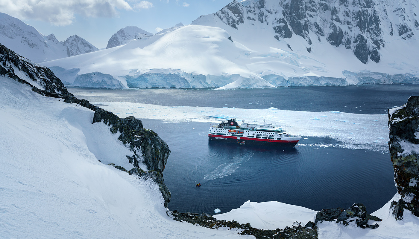 Hurtigruten ship surrounded by water and snow in Antarctica