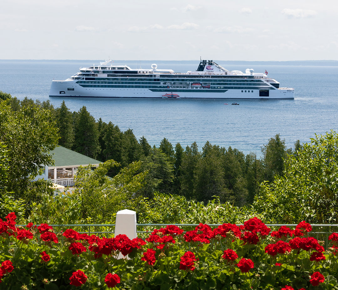 A Viking Cruise ship in the Great Lakes as viewed from a cliff on an island.